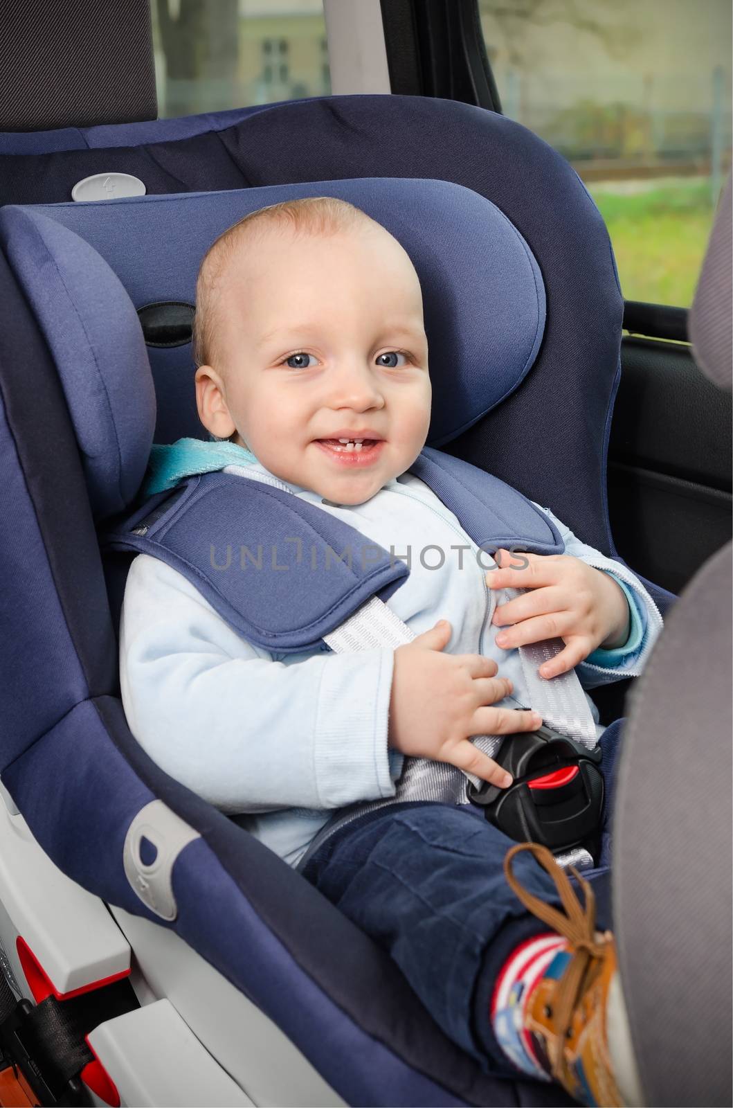 Cute boy sitting in the car seat 