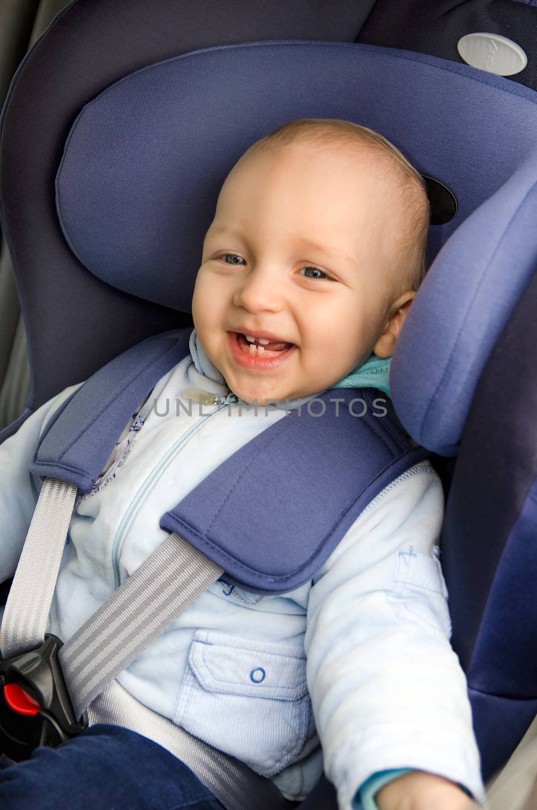 Cute boy sitting in the car seat 