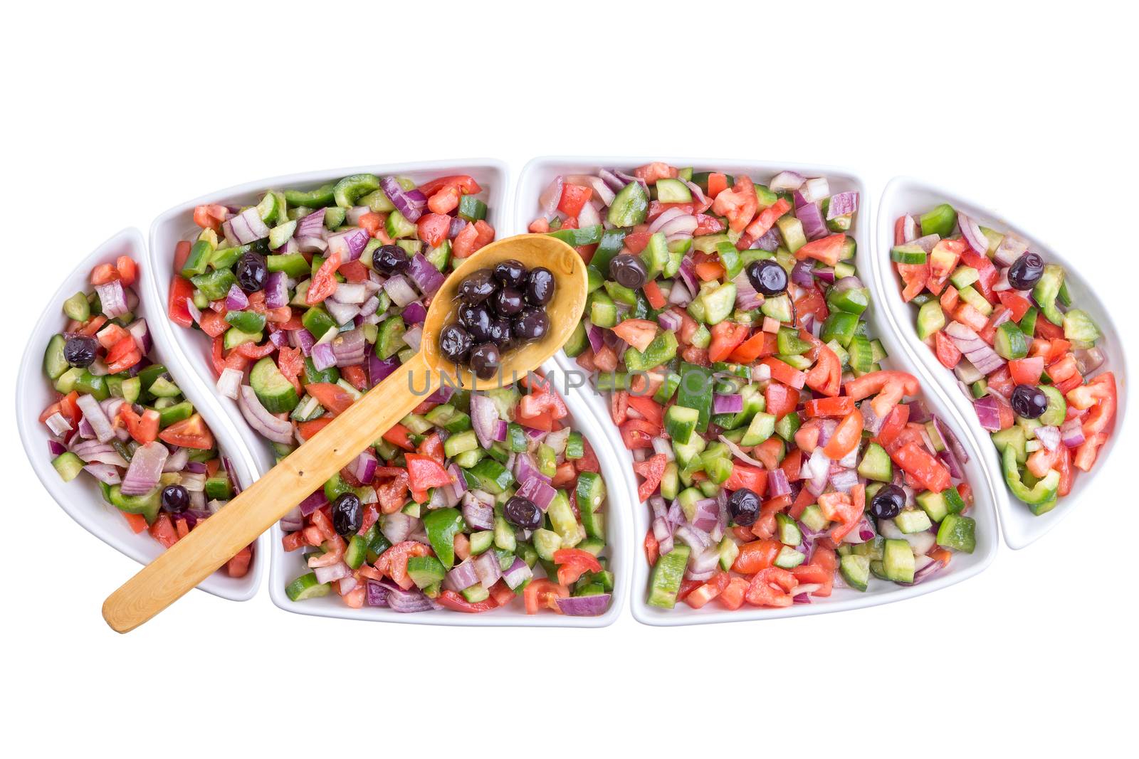 Turkish shepherd salad with colorful diced fresh vegetable served with olives in a long oval platter for a family gathering, overhead view isolated on white