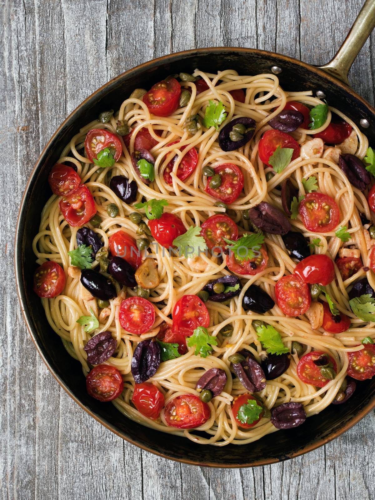 close up of rustic italian spaghetti puttanesca pasta