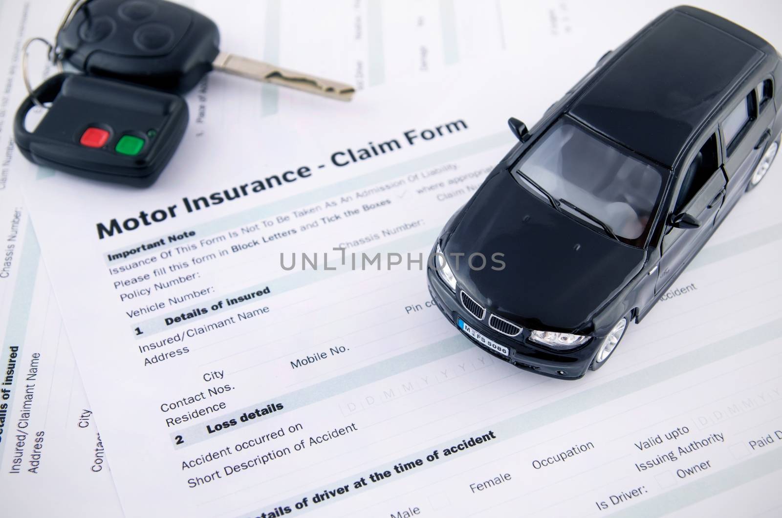 Car toy and keys on insurance documents . Protection car concept by simpson33