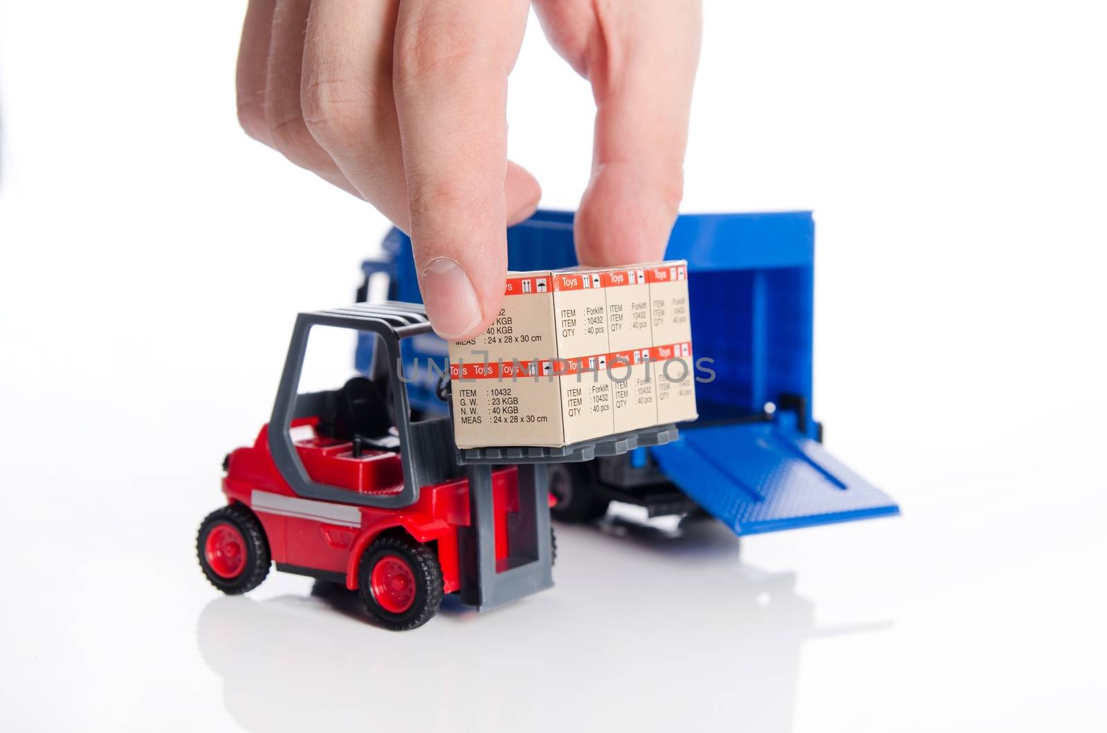 Hand taking boxes from forklift toy. Concept of international fr by simpson33