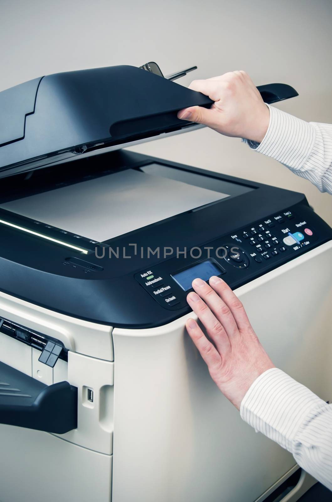 Man using scanner multifunction device in office