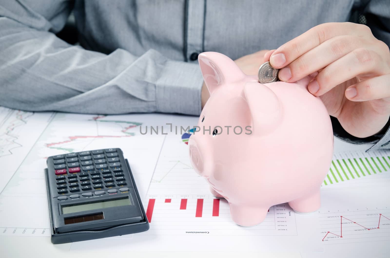 Man putting coin in piggy bank. Saving money concept