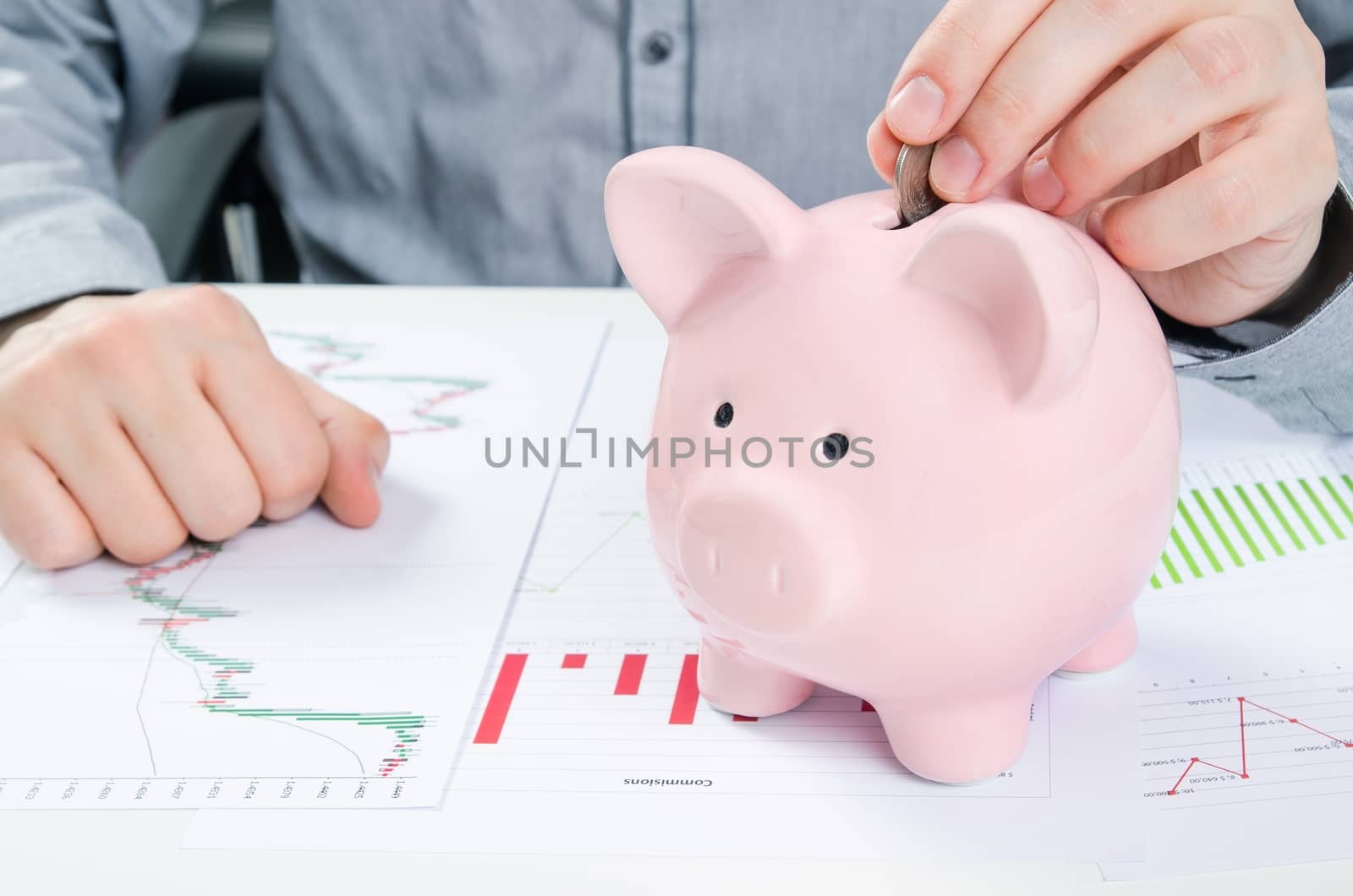 Man putting coin in piggy bank. Saving money concept