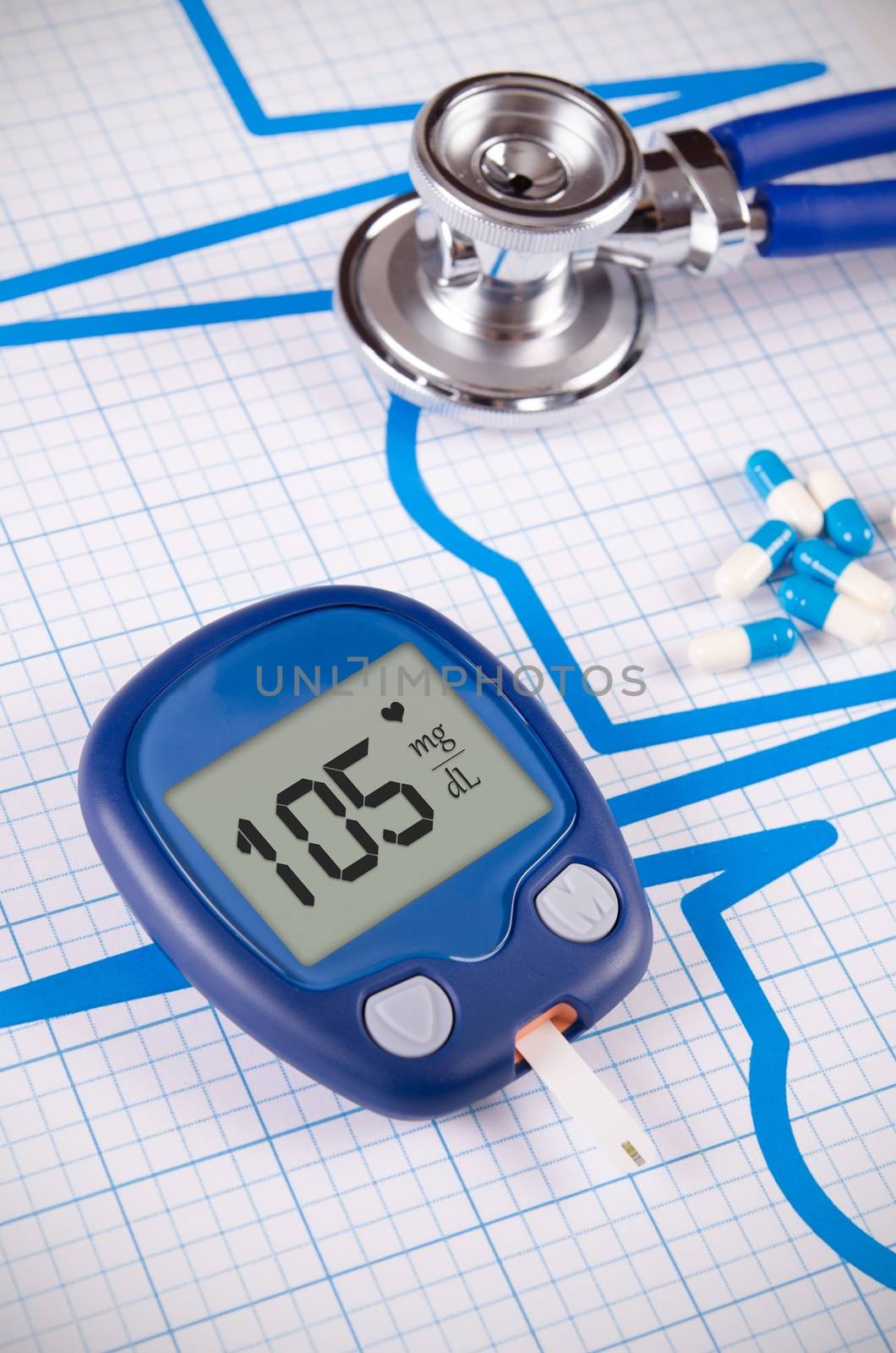 Glucometer and stethoscope on medical background