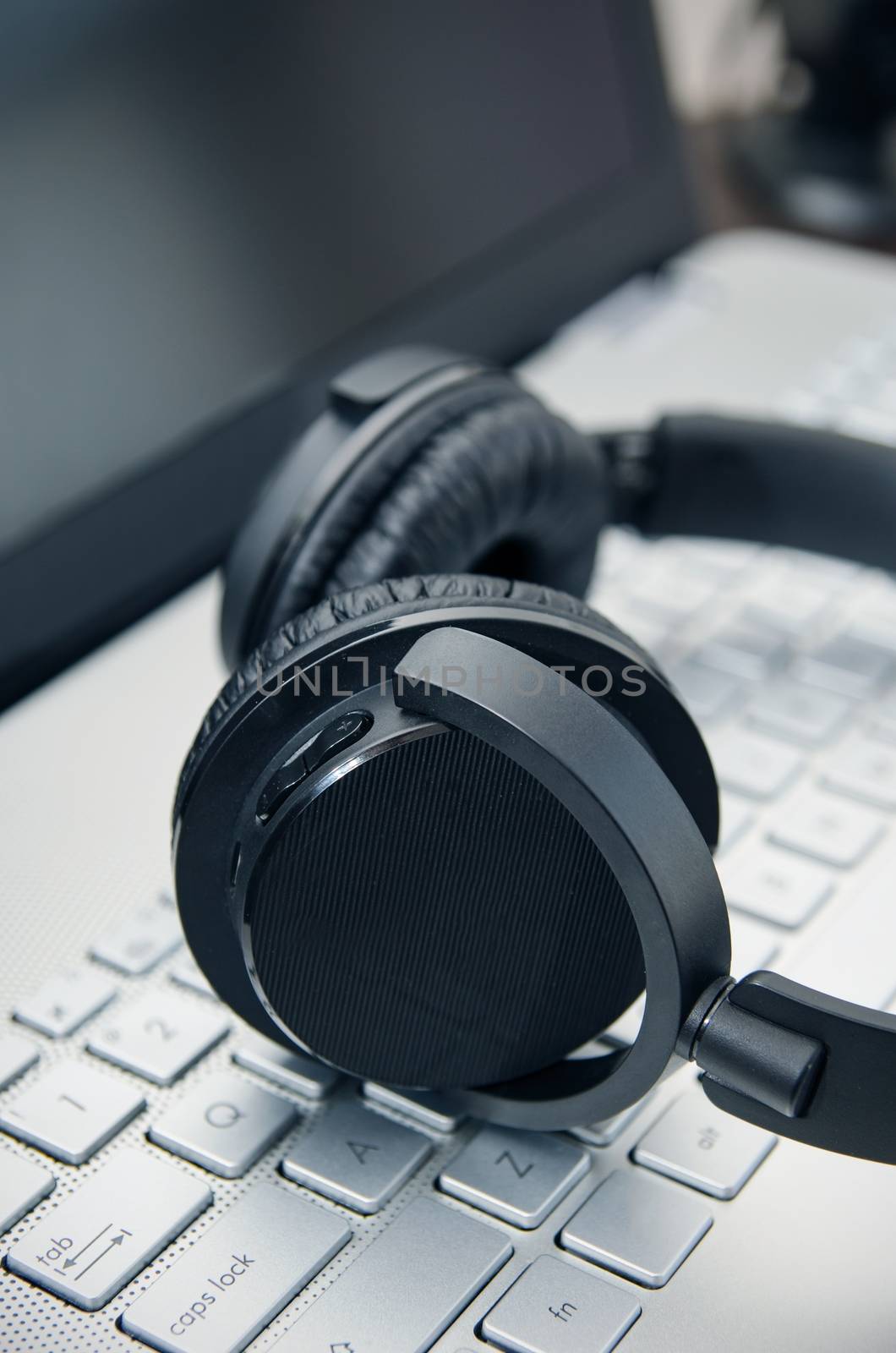 Wireless headphones on laptop keyboard. Music and gaming concept.