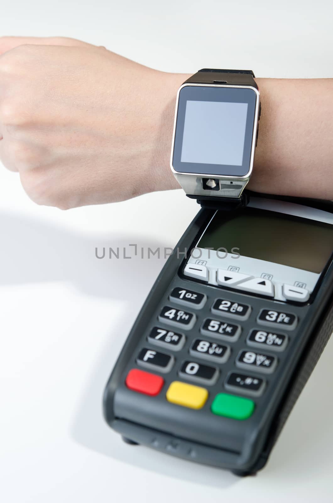 Man making payment through smartwatch via NFC technology by simpson33