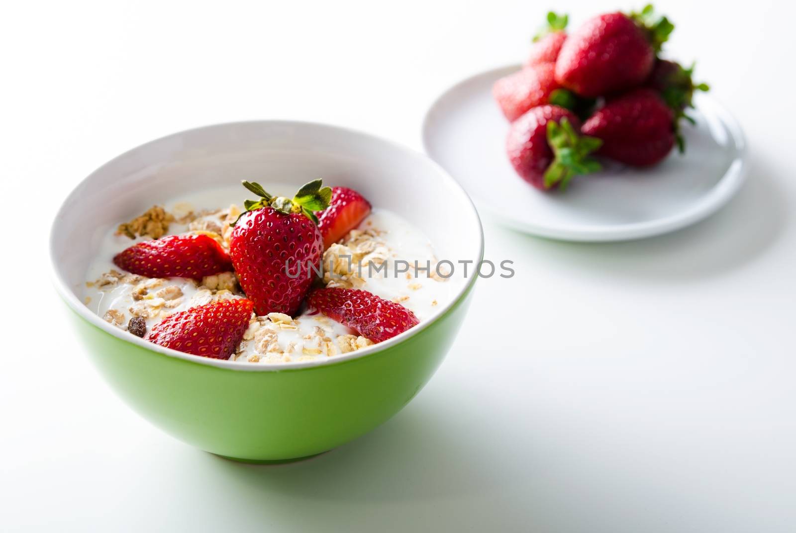 Close up of homemade fruit plate with yogurt, strawberries, on white background