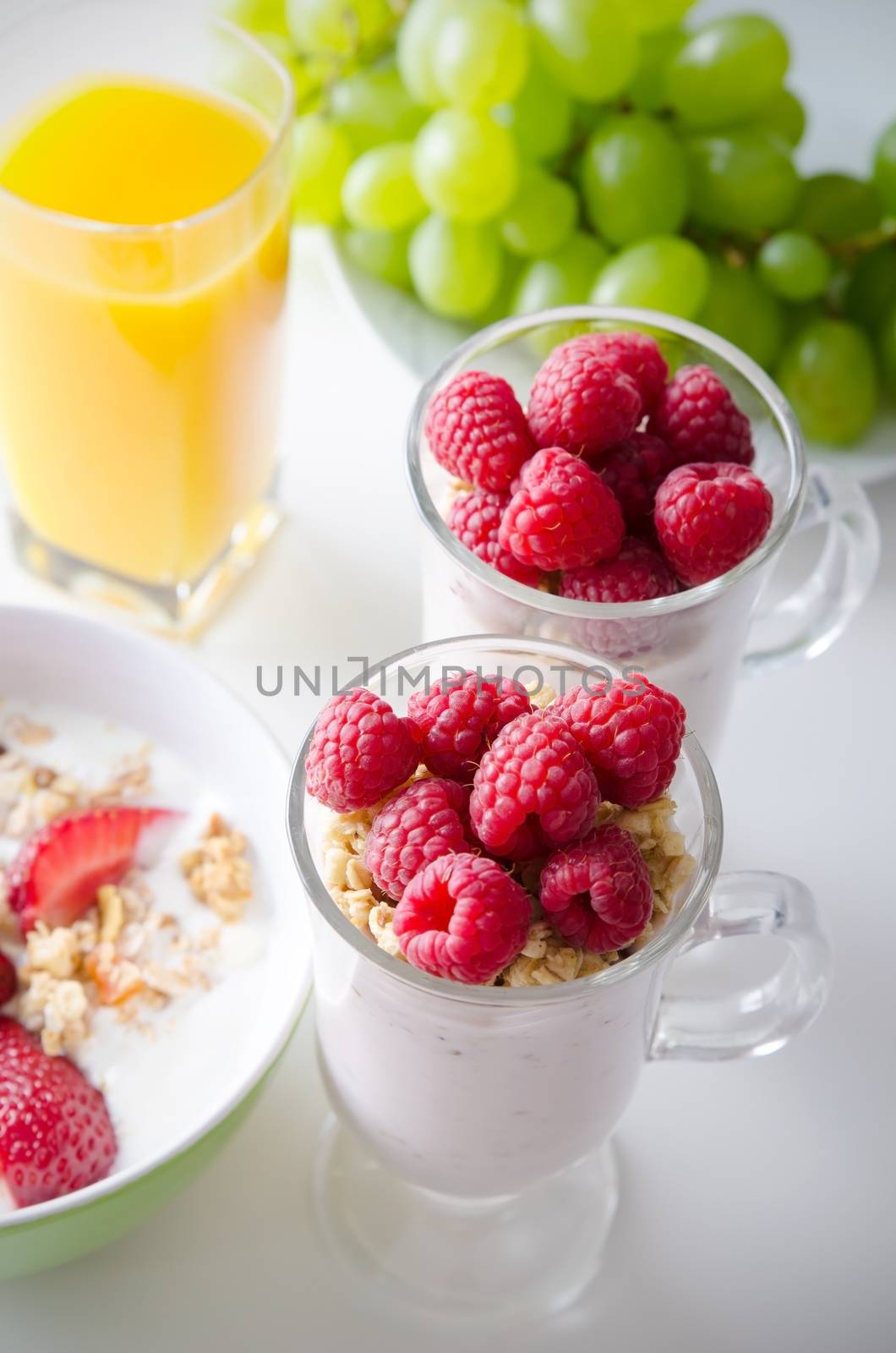 Glass of dessert with fresh berries, muesli and yoghurt by simpson33