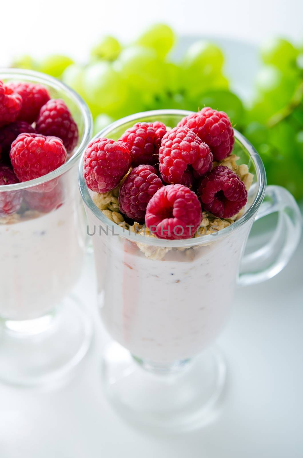 Glass of dessert with yoghurt, fresh berries and muesli by simpson33