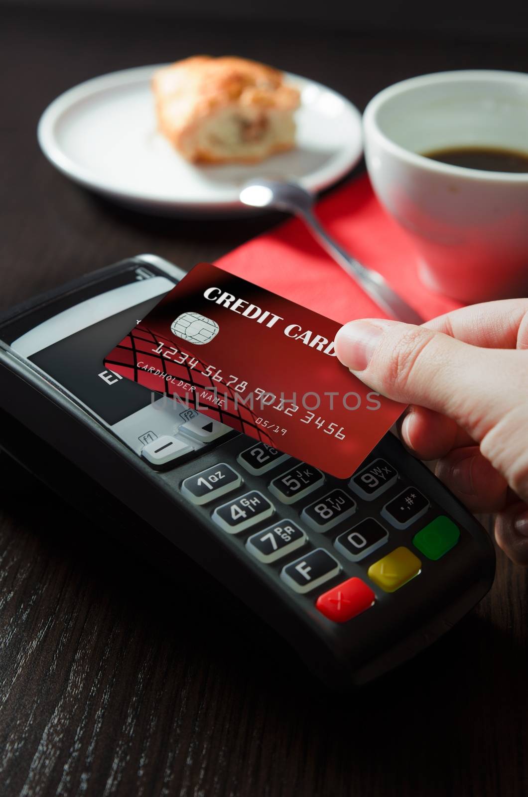 Man using payment terminal with NFC contactless technology in cafeteria