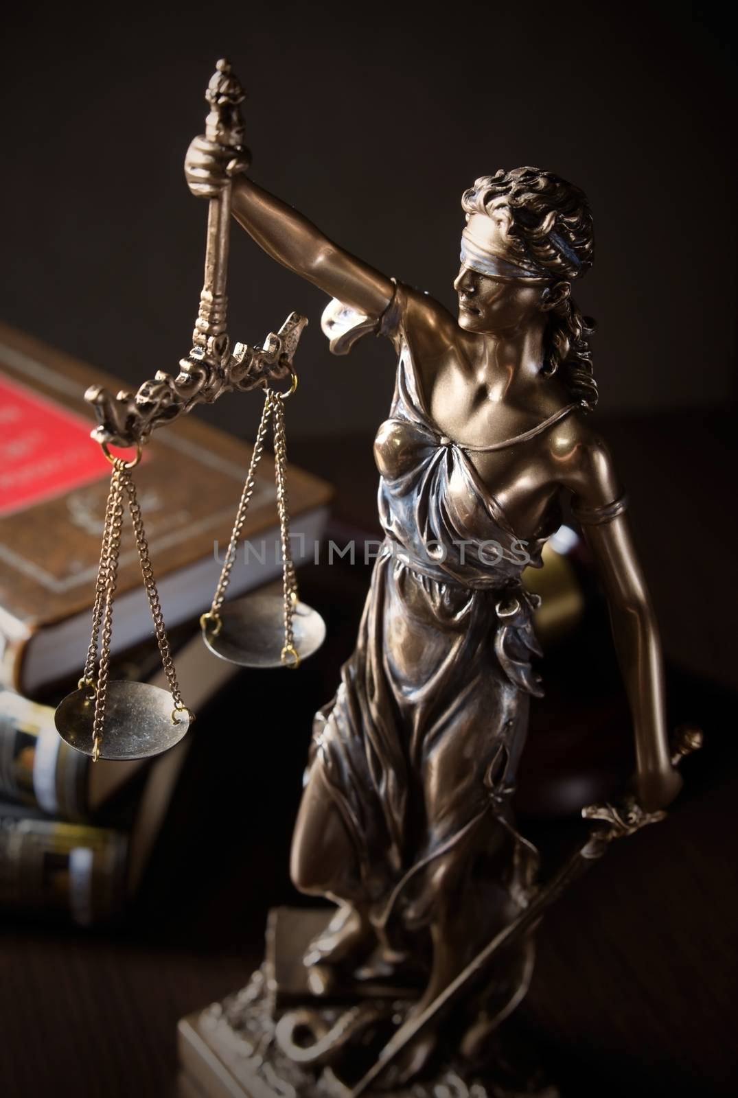 Law concept with Themis and books in background by simpson33