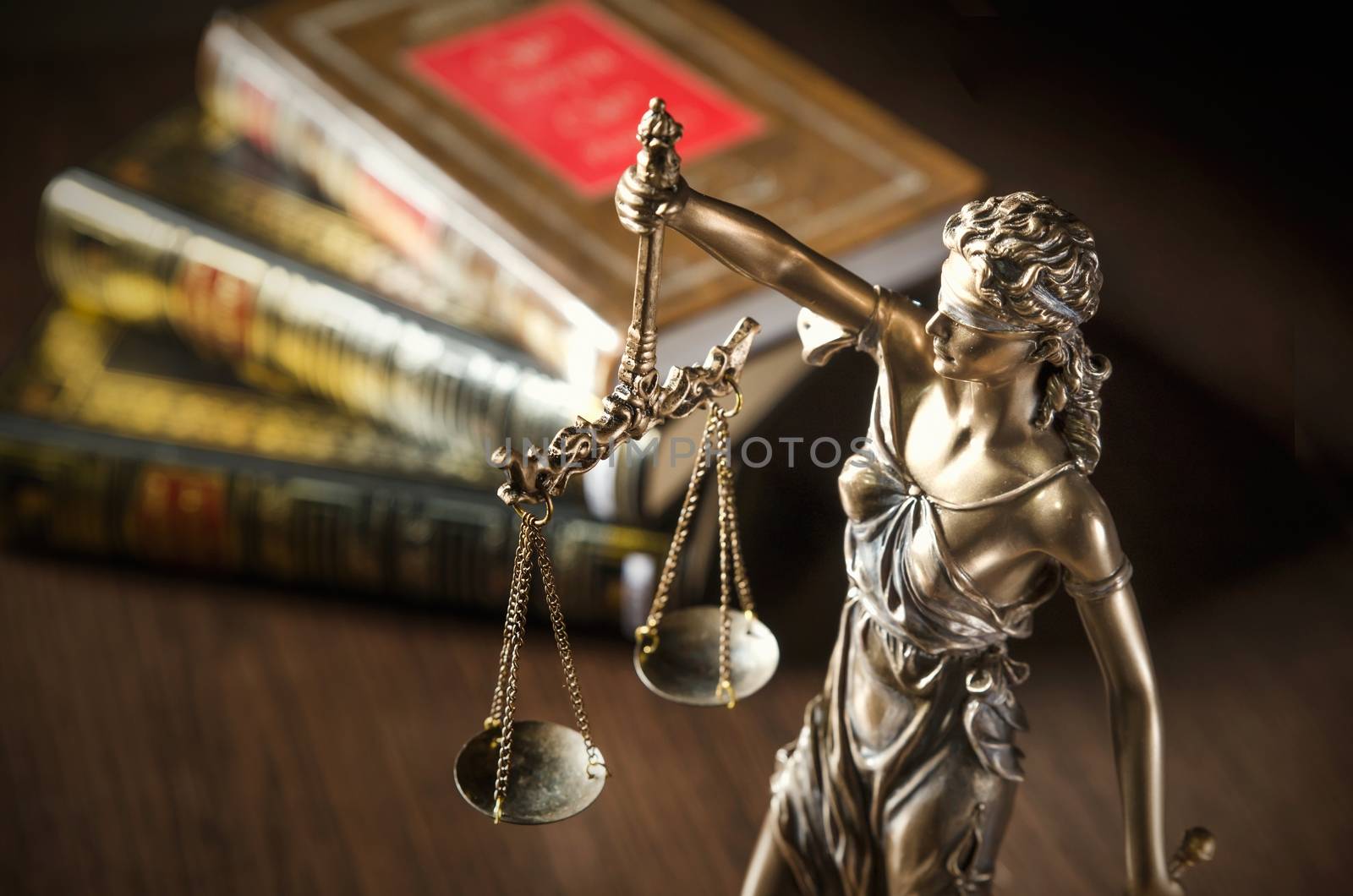 Law concept with Themis and books in background. Composition in court library