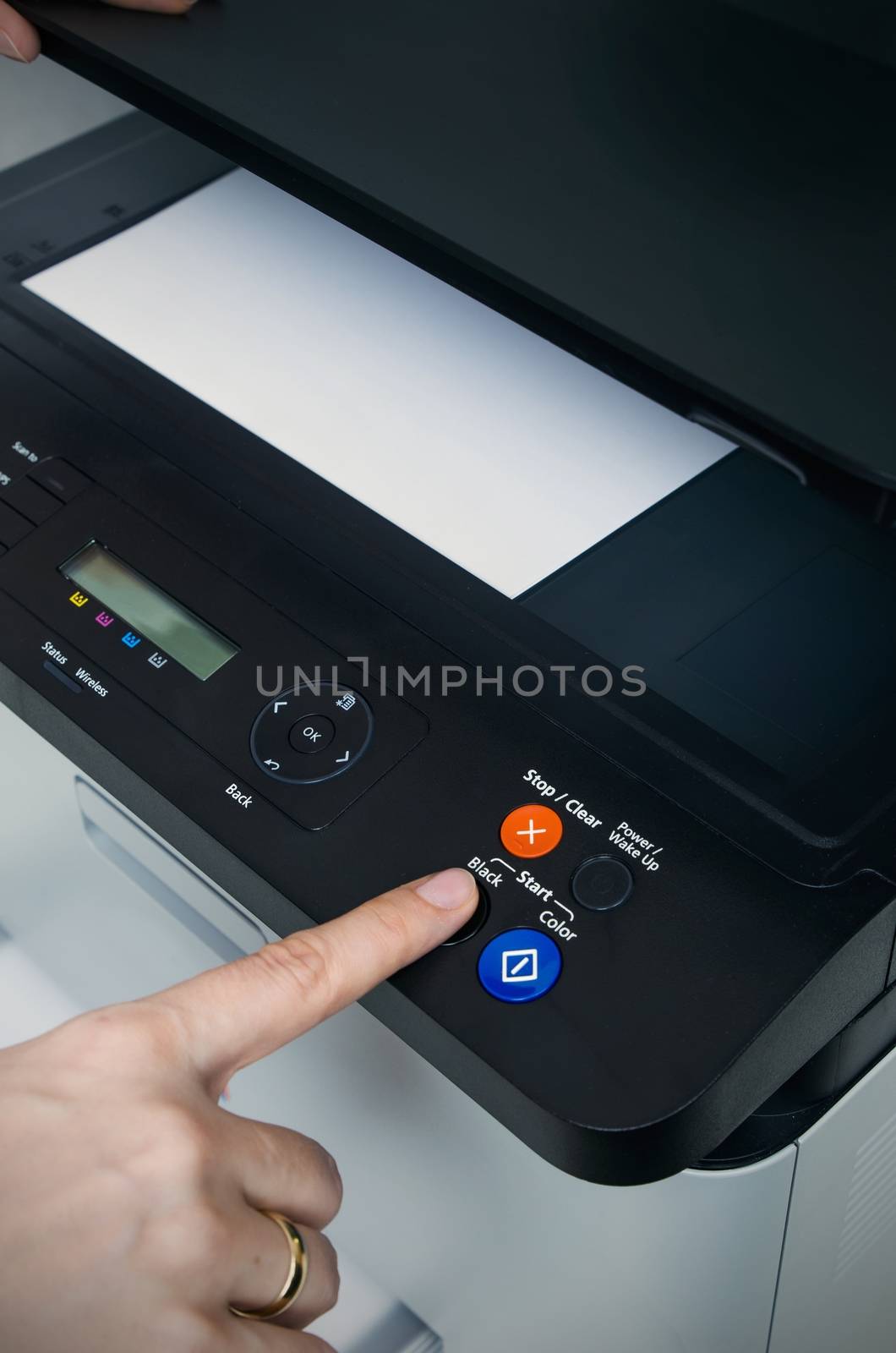 Woman switching on start button of laser printer by simpson33