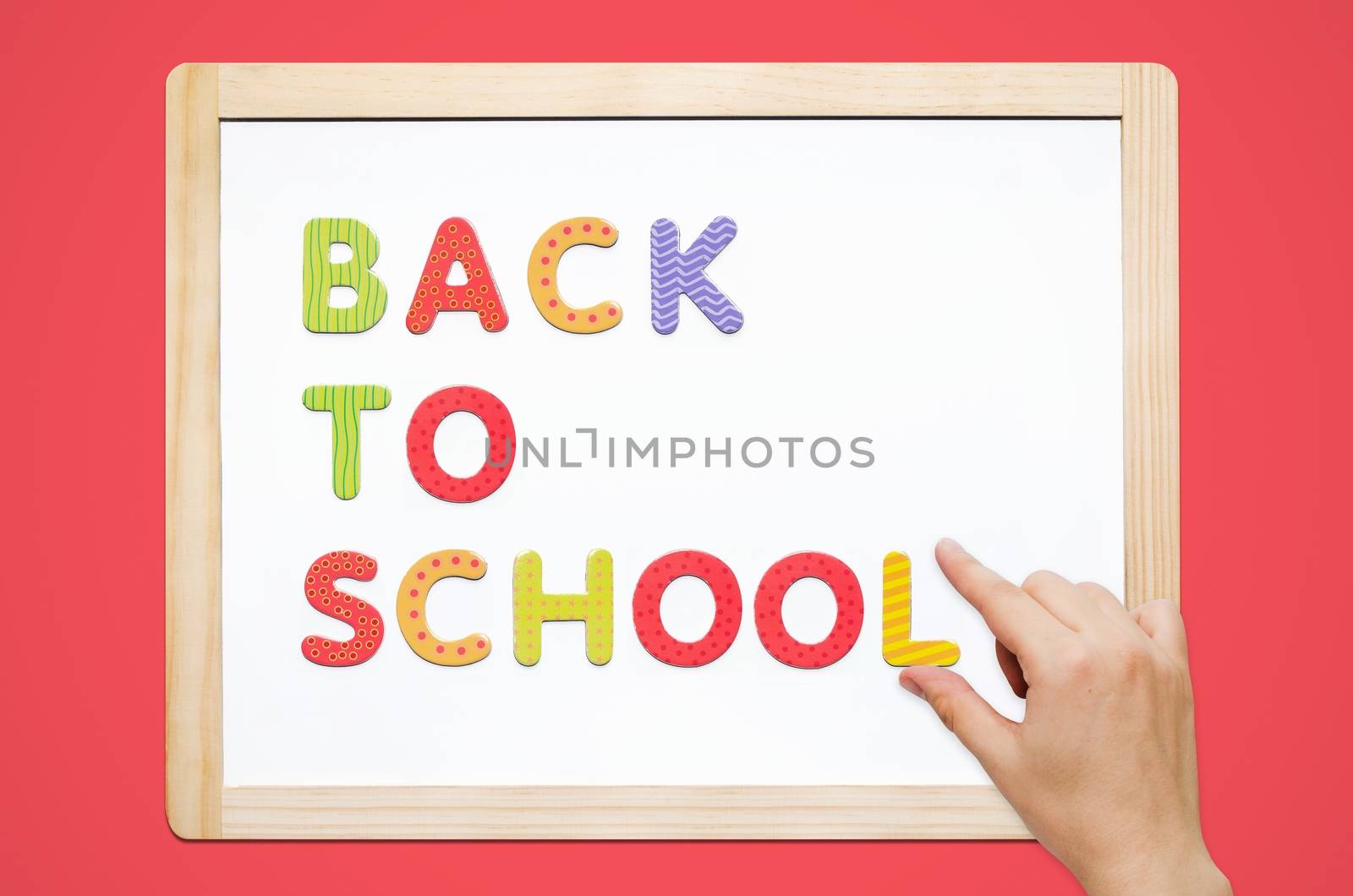 Hand put the words Back To School on magnetic board by simpson33