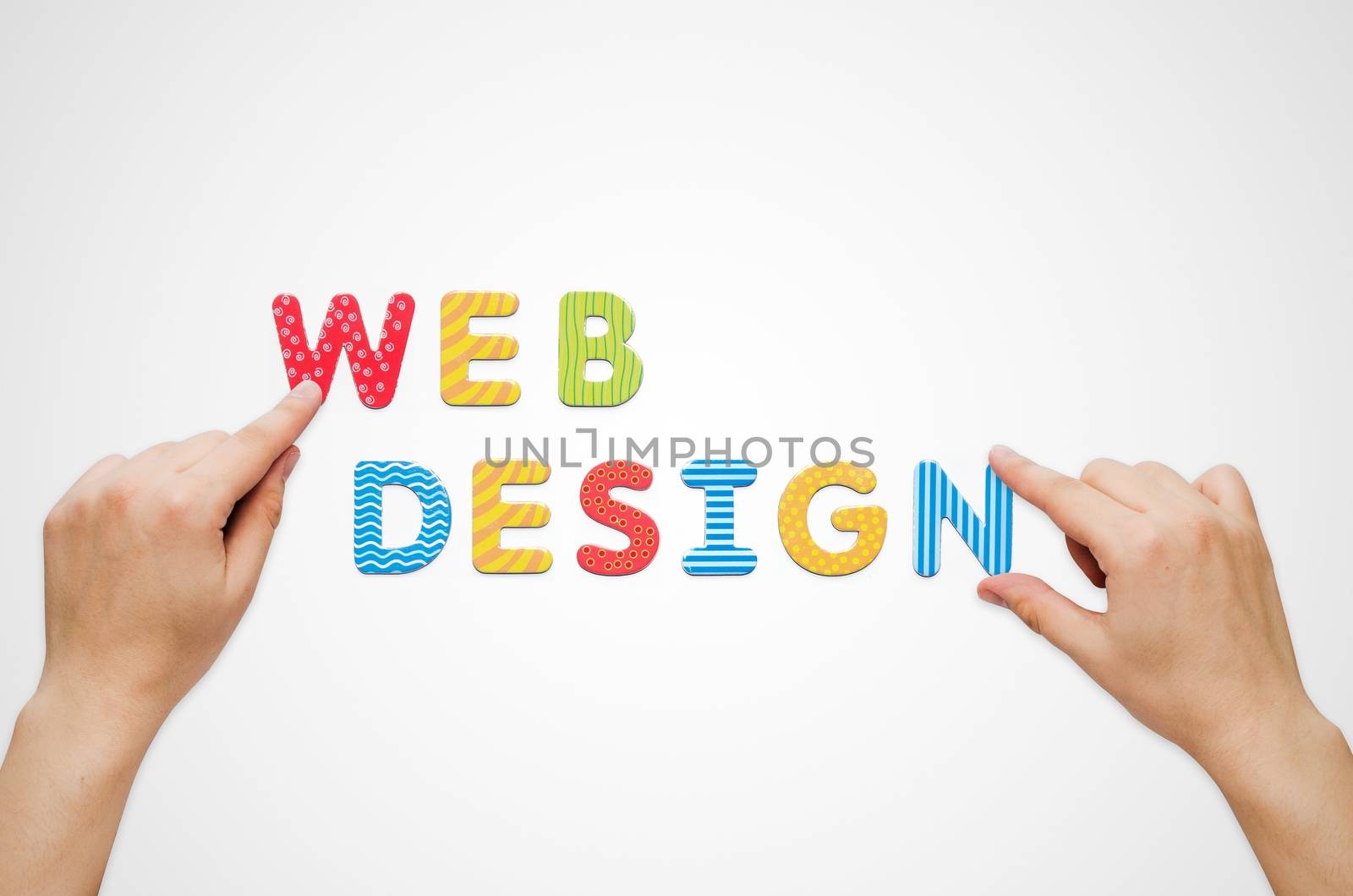 Hands put the words Web Design with magnetic letters by simpson33