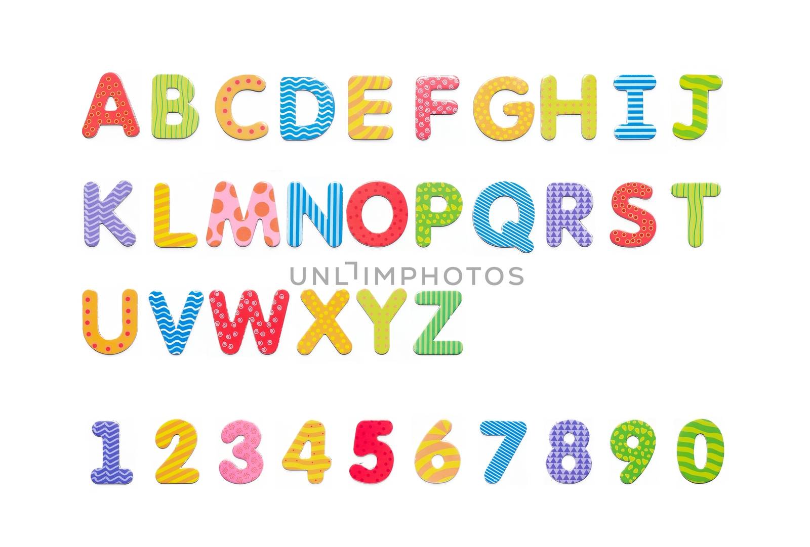 Colorful paper alphabet magnets on a whiteboard. Letters set isolated on white background