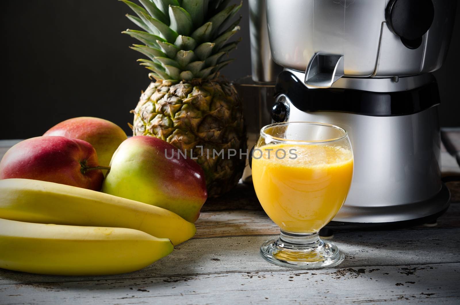 Fresh juice and juicer. Photo on wooden background  by simpson33