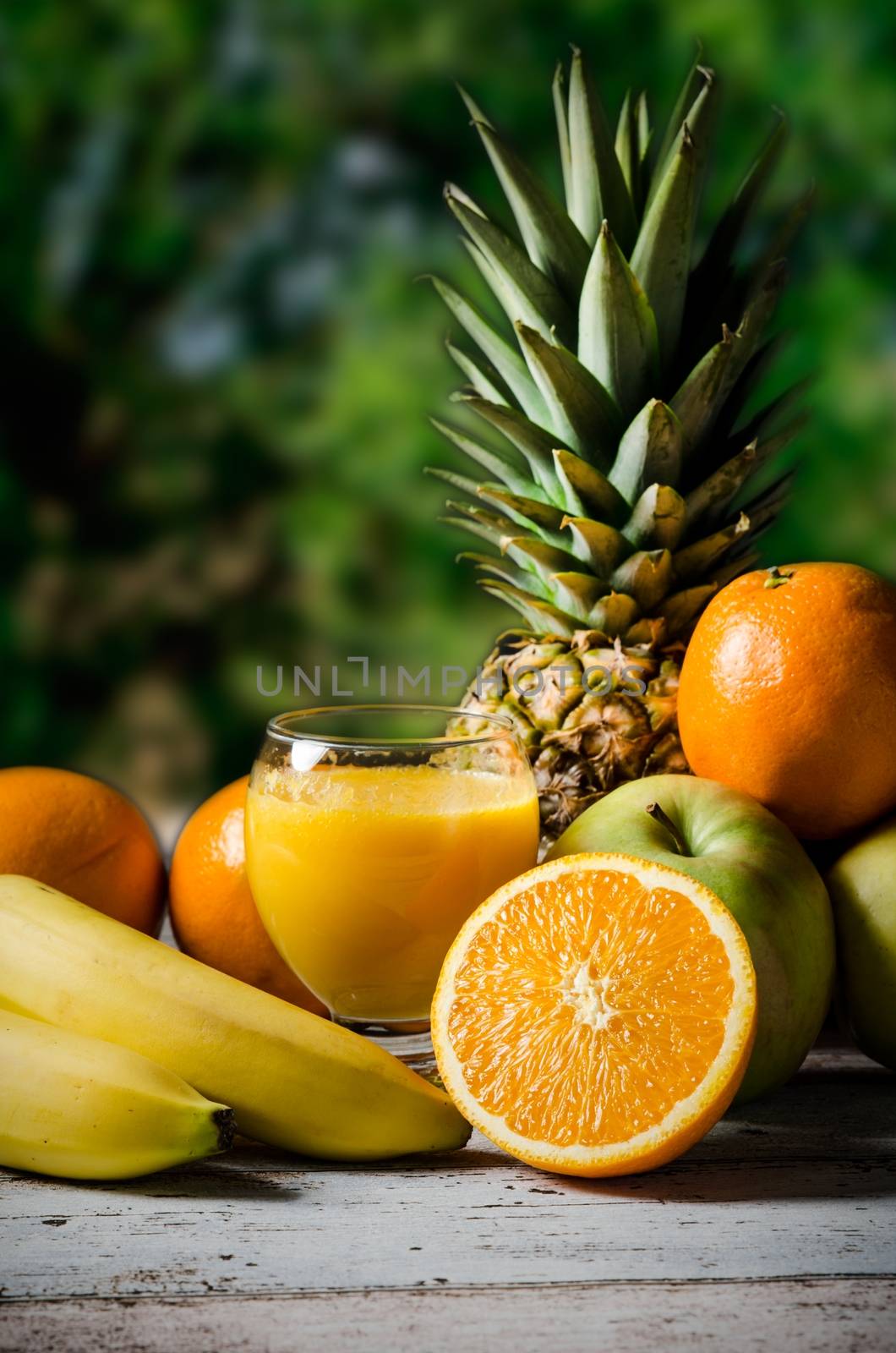 Lot of fresh fruits on wooden background. Photo on nature