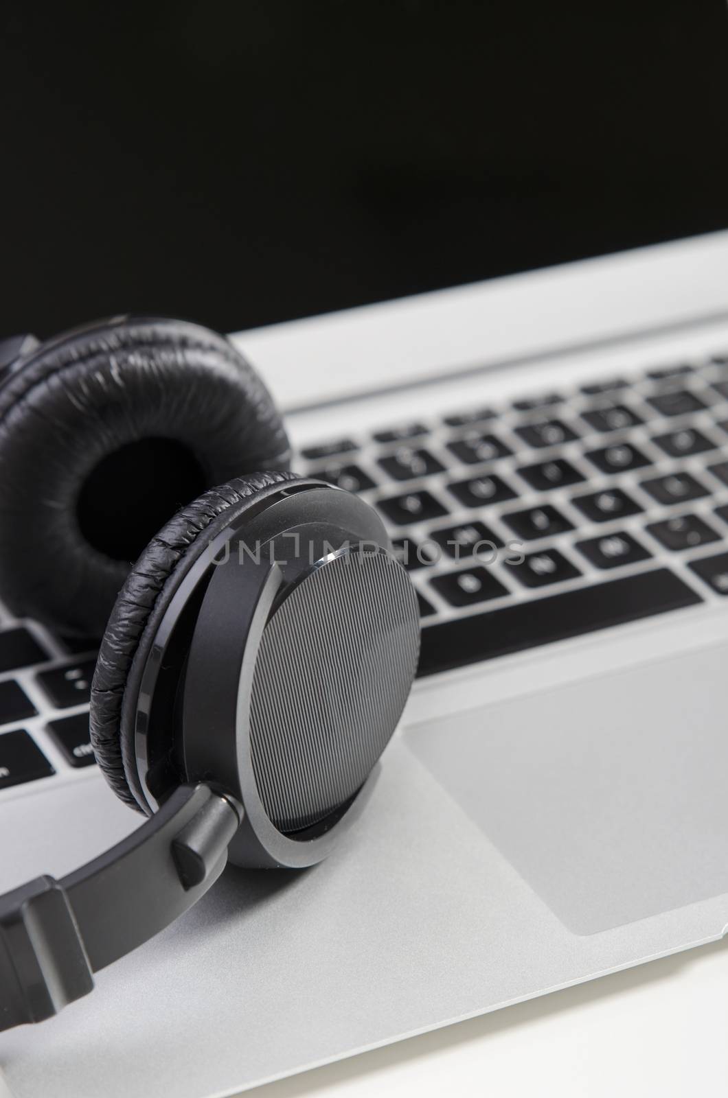 Close up of audio headset on laptop. Wireless headphones