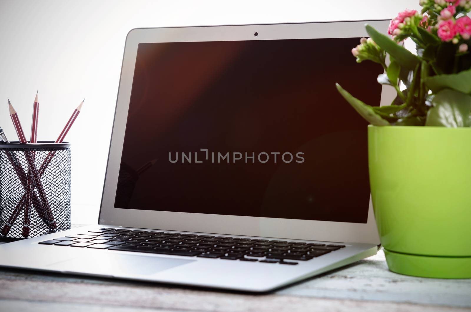 Laptop on desk in modern office mockup. Use for web design presentation