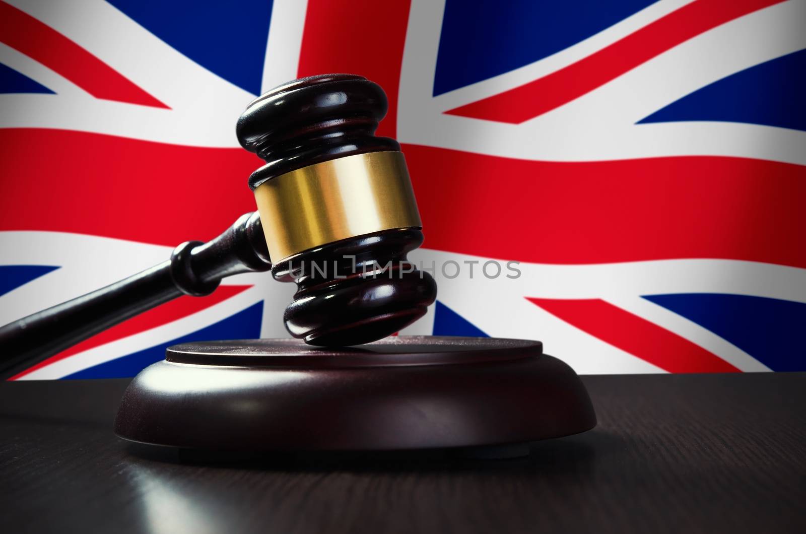 Wooden gavel with United Kingdom flag in background by simpson33