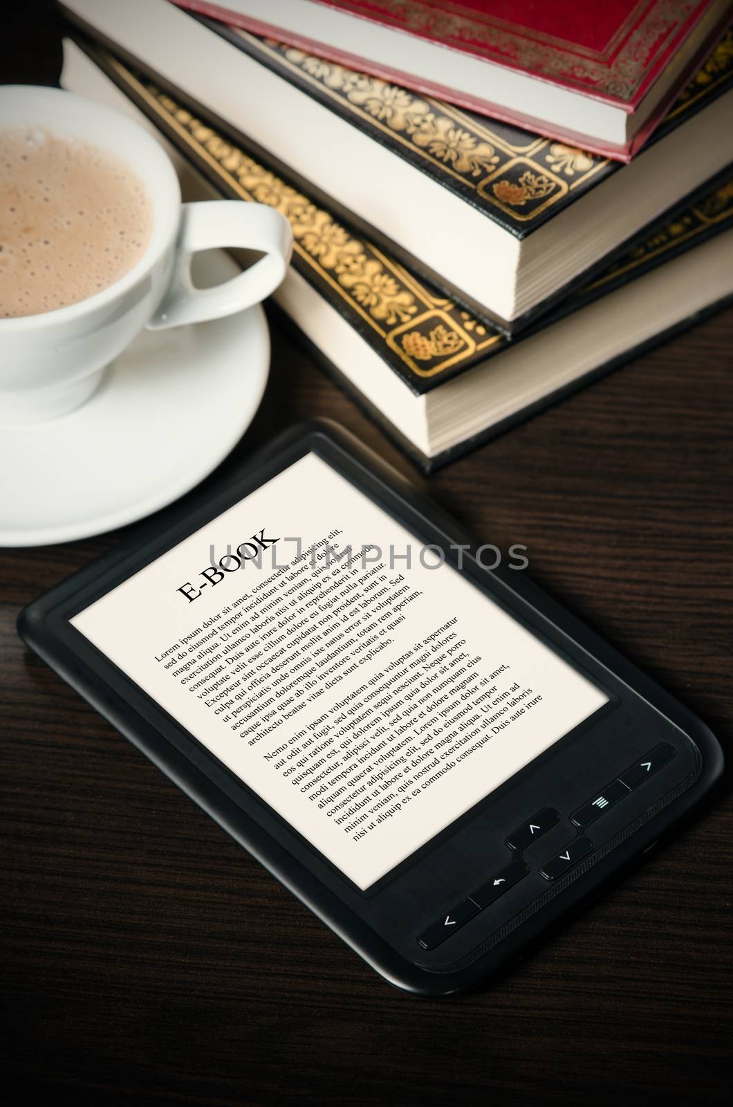 E-book reader device on desk in library by simpson33