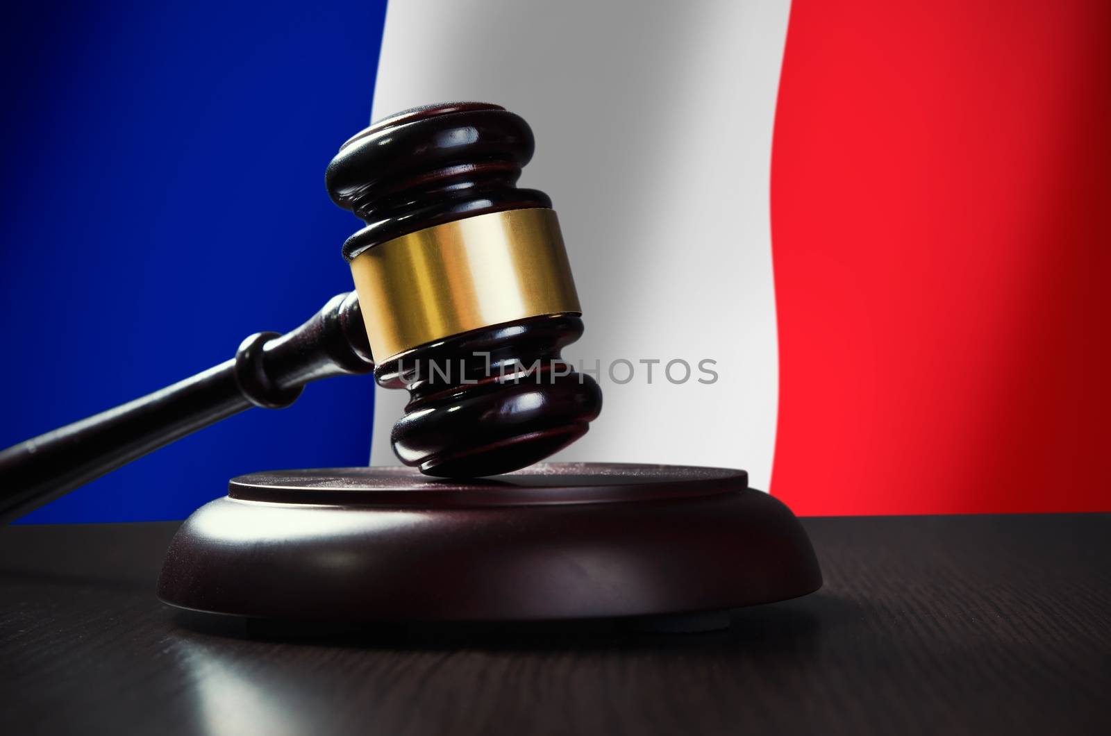 Wooden gavel with French flag in background by simpson33