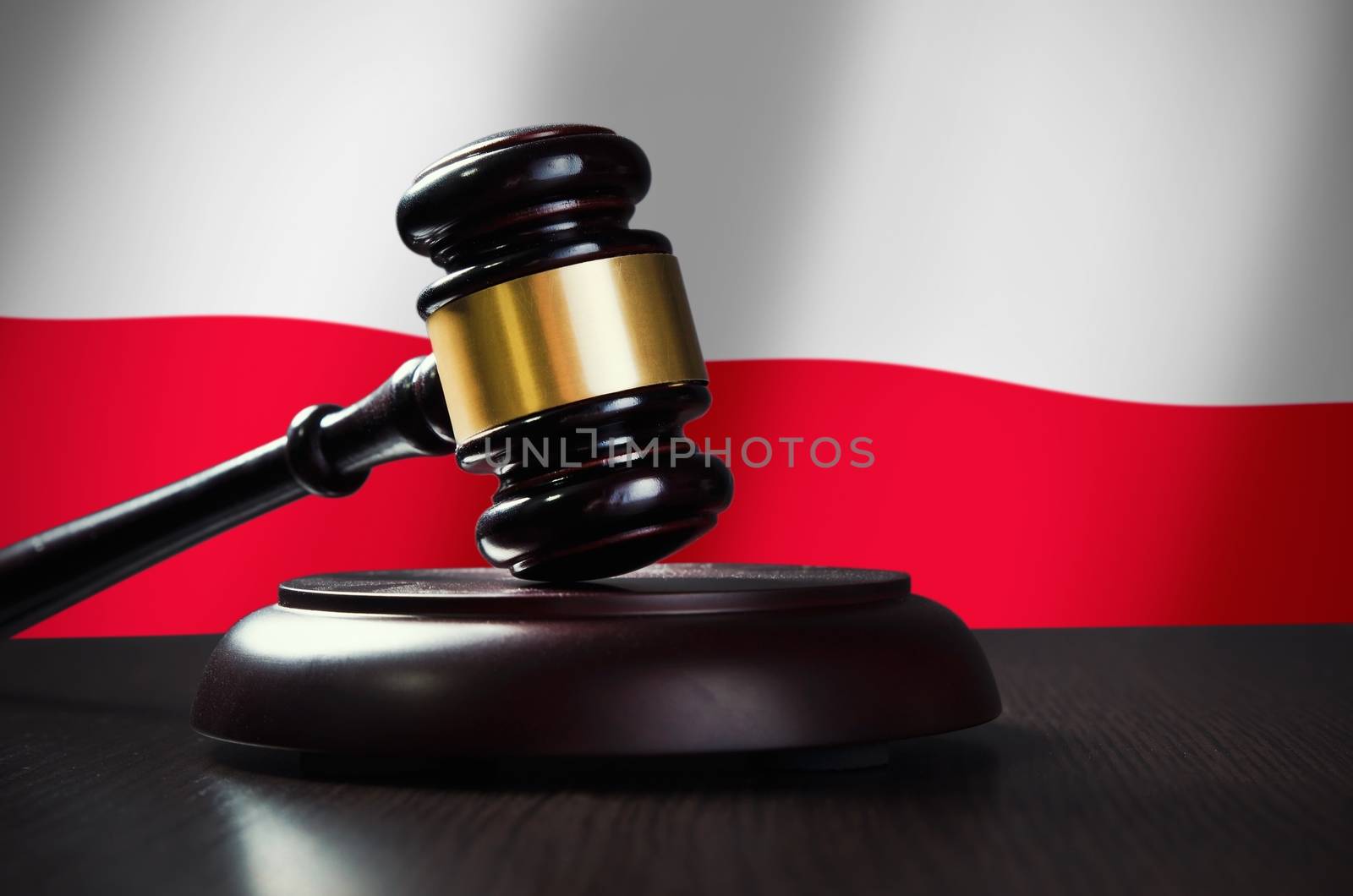 Wooden gavel with Polish flag in background. Justice and law symbol