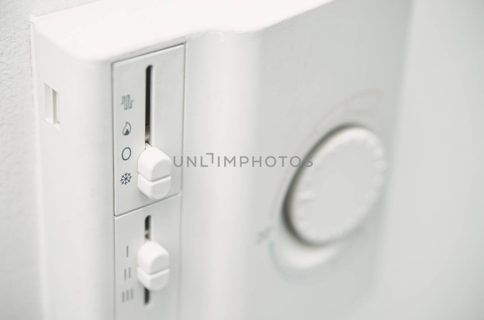 Air conditioner thermostat on wall. Close up photo by simpson33