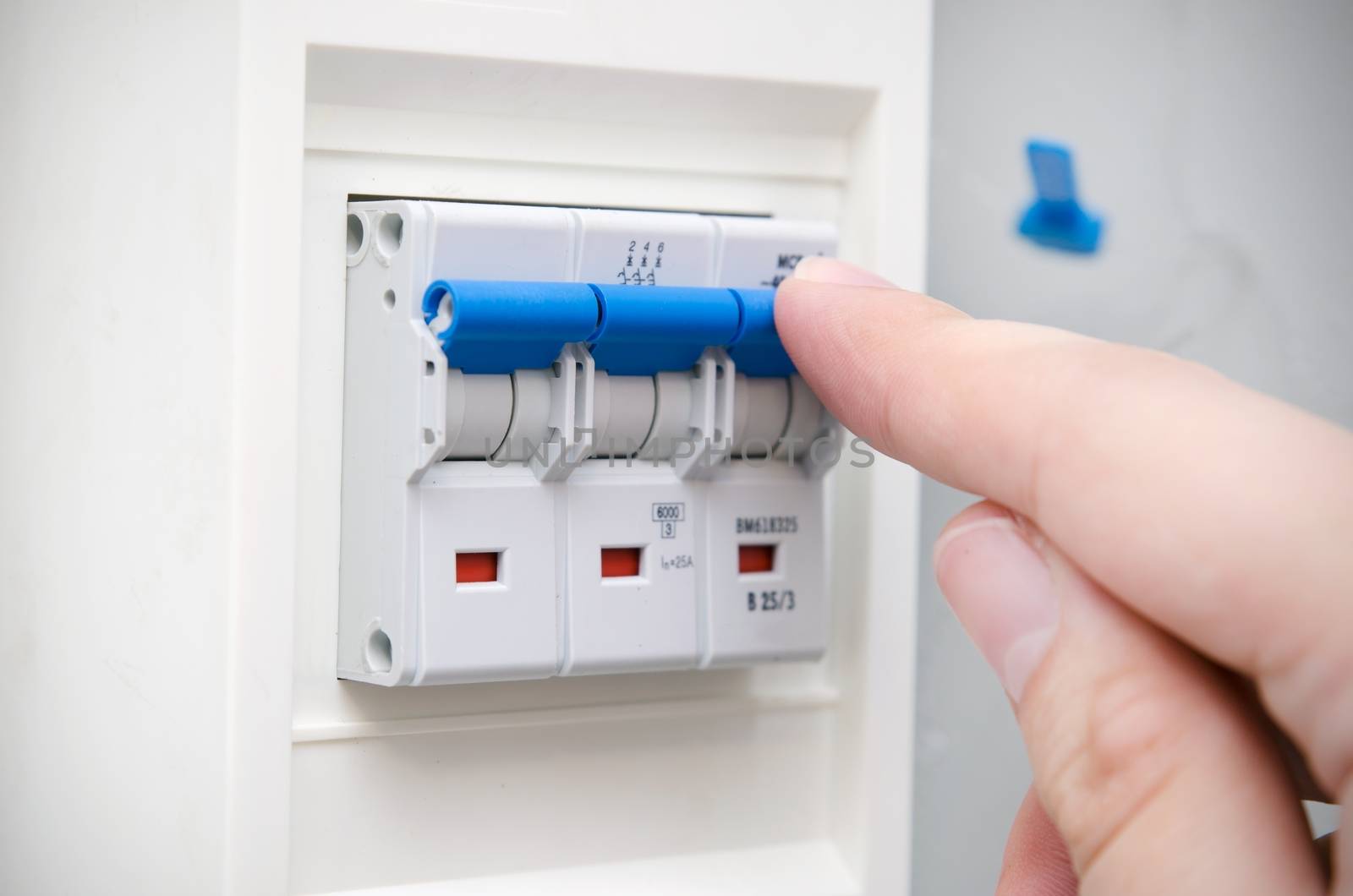 Man switches automatic fuse. Electric equipment close up by simpson33