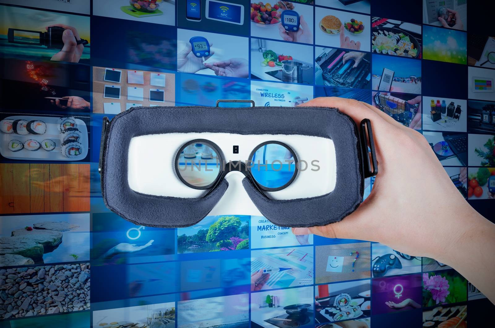 Hand holding virtual reality glasses with streaming multimedia in background