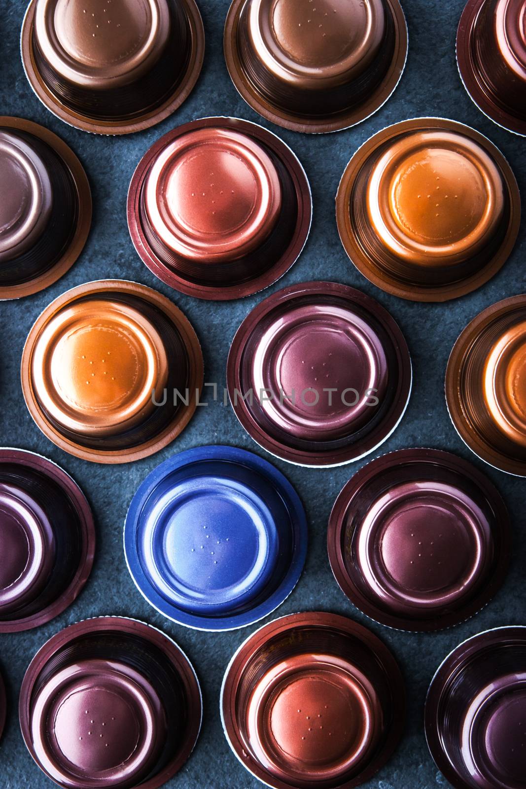 Coffee capsules on the dark table vertical