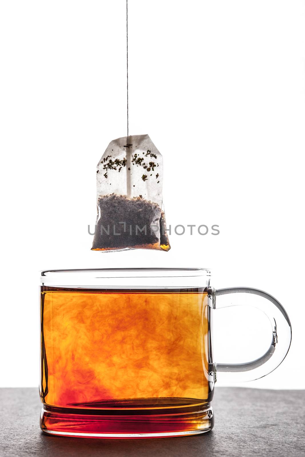 Brewed tea with tea bag vertical