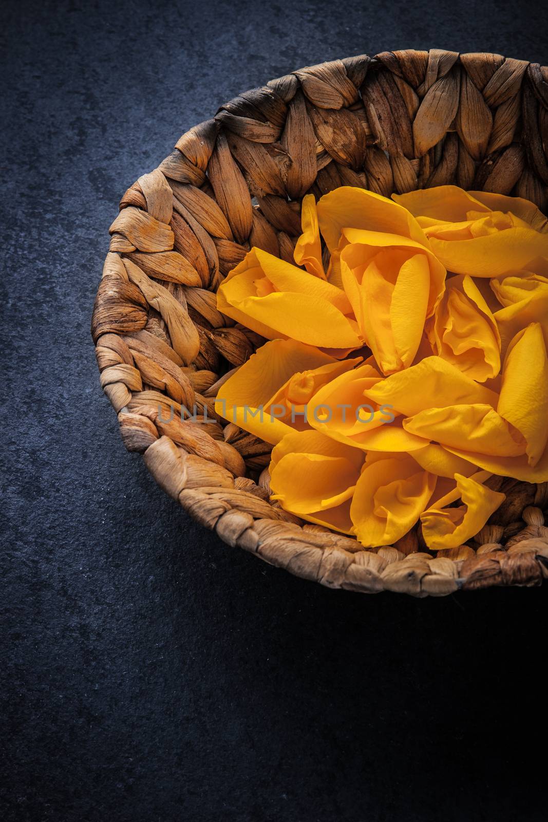 Rose petal  in the wicker bowl vertical