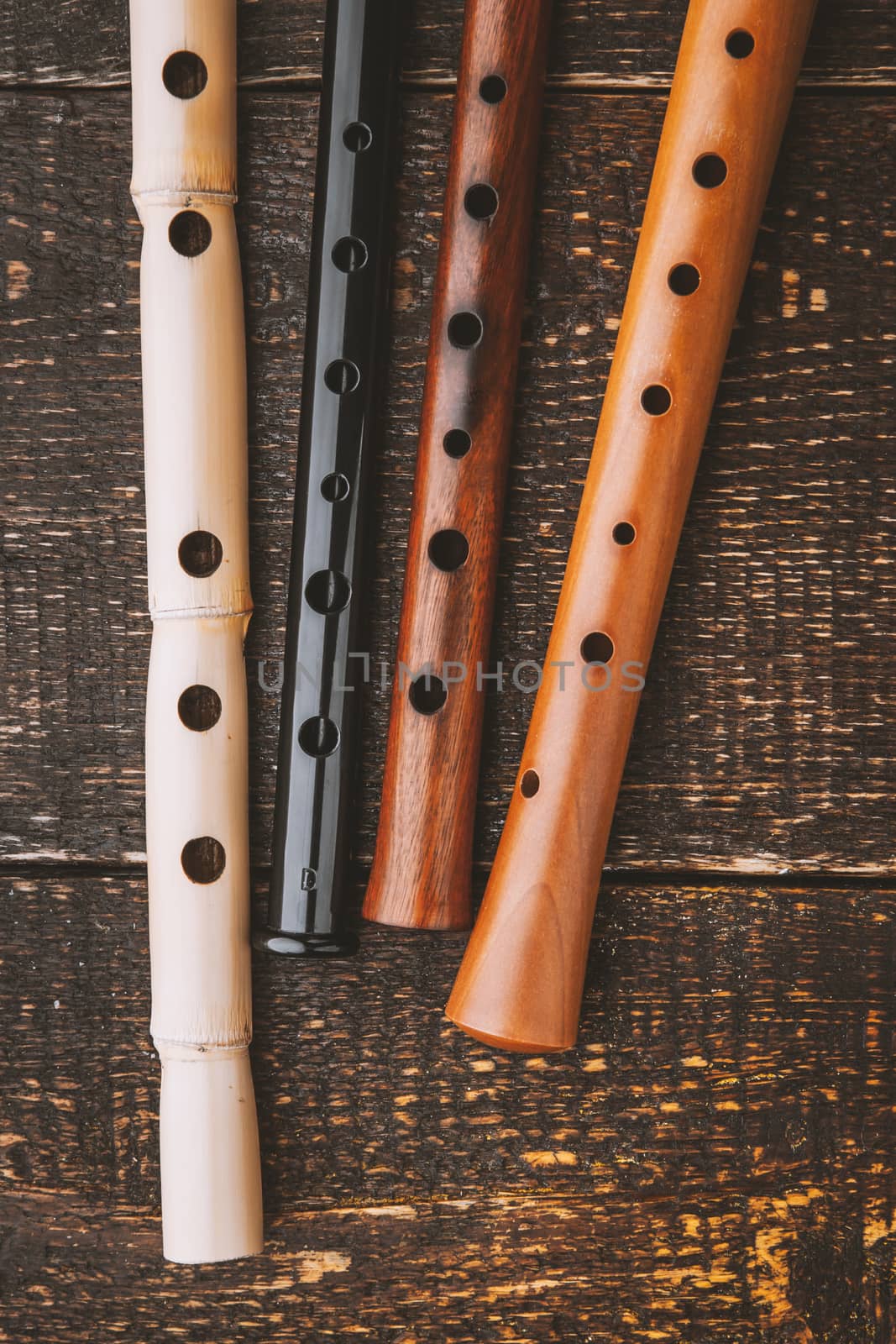 Set of flutes  on the wooden table vertical by Deniskarpenkov