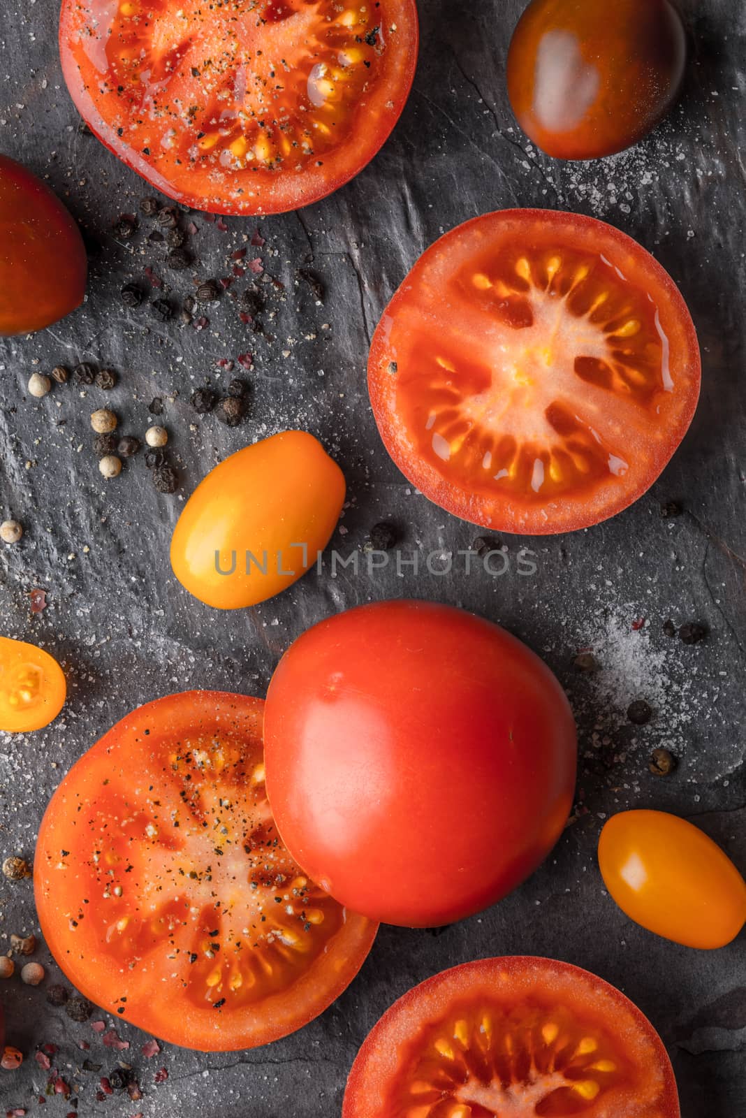 Tomatoes mix  with seasoning on the stone table vertical