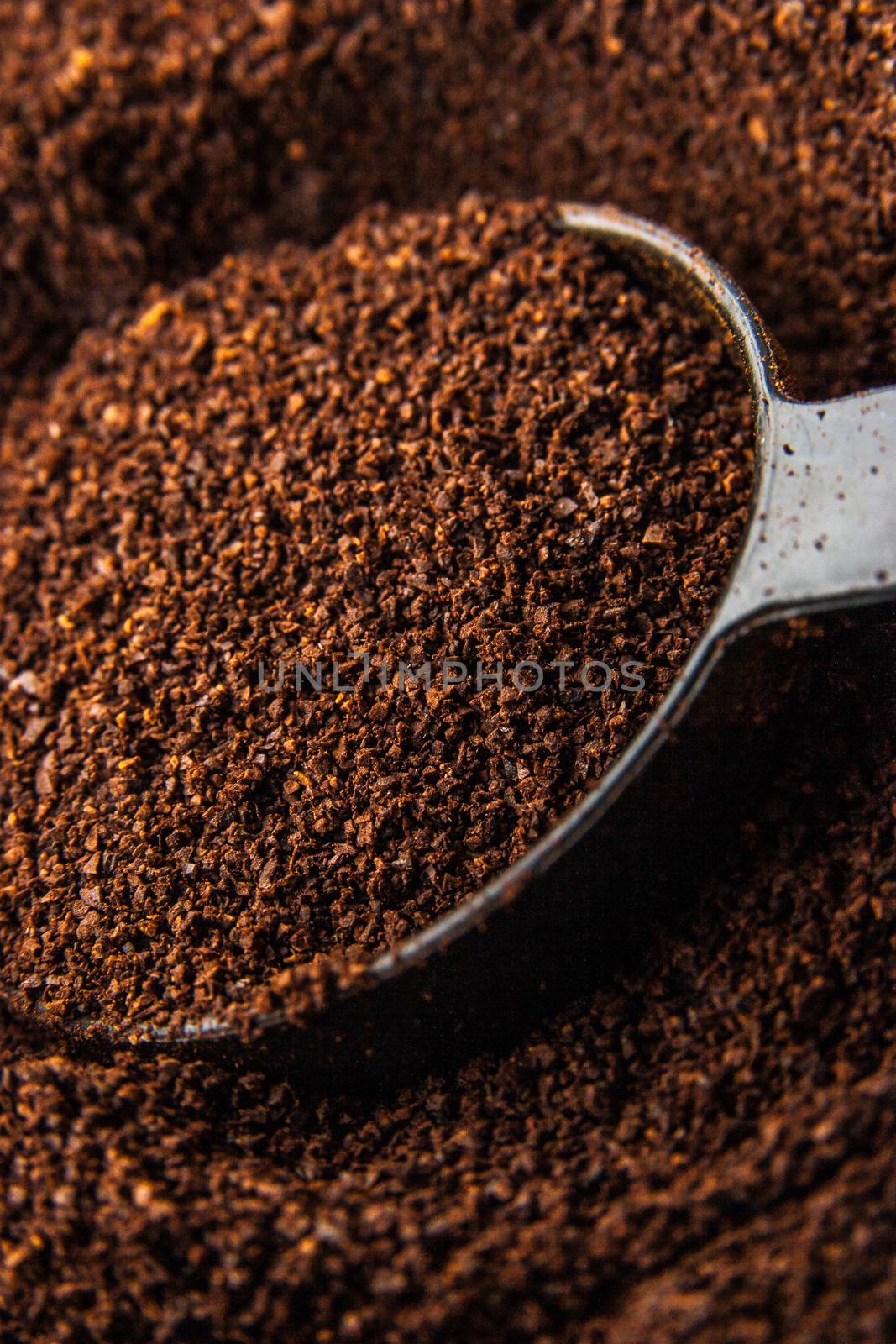 Ground coffee with spoon background