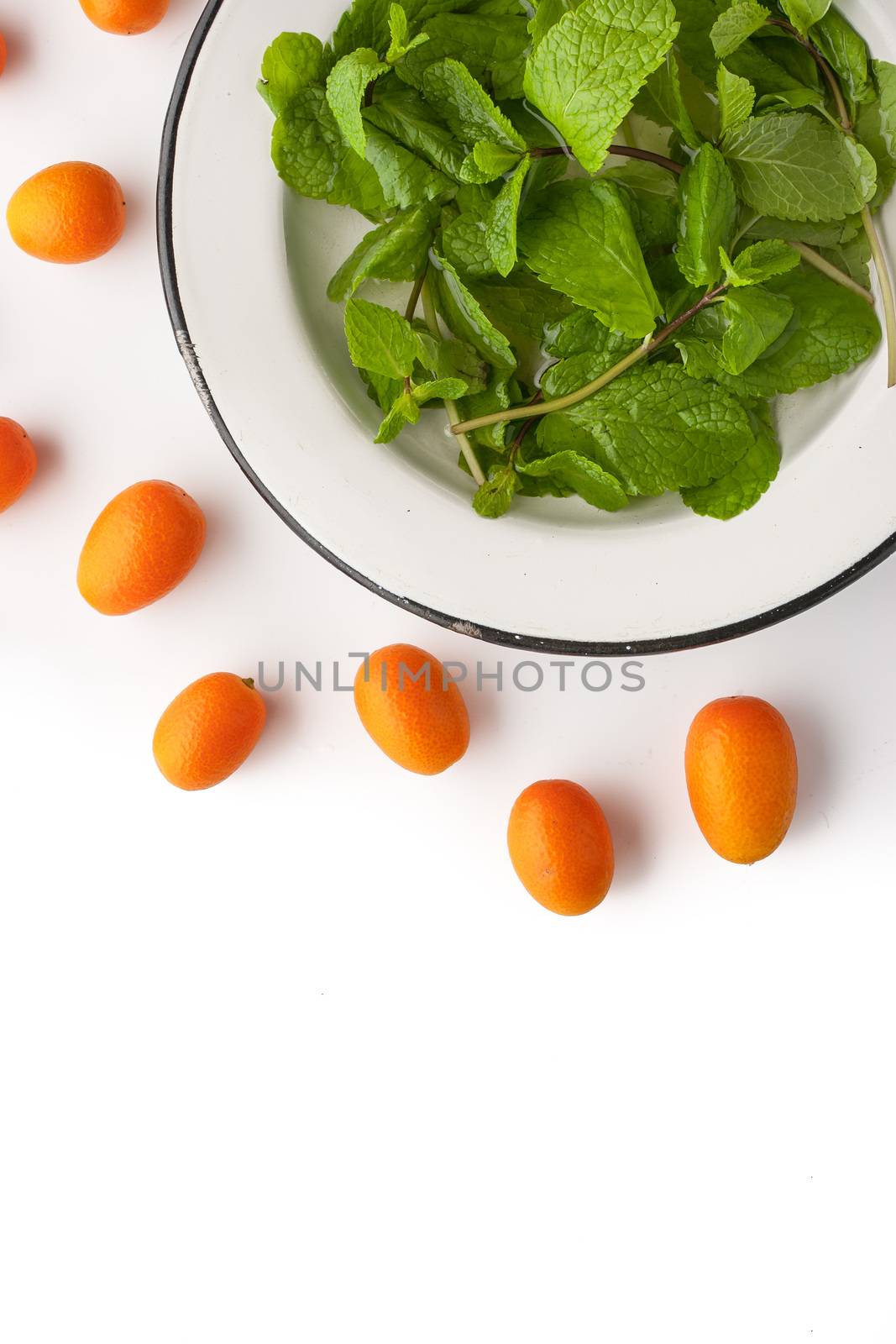 Mint with kumquat on the white background