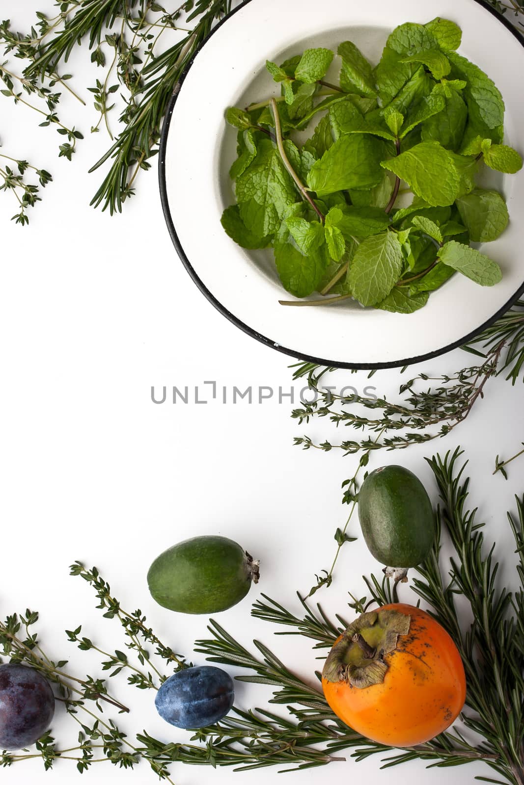Herbs and fruit mix on the white background verticalФ
