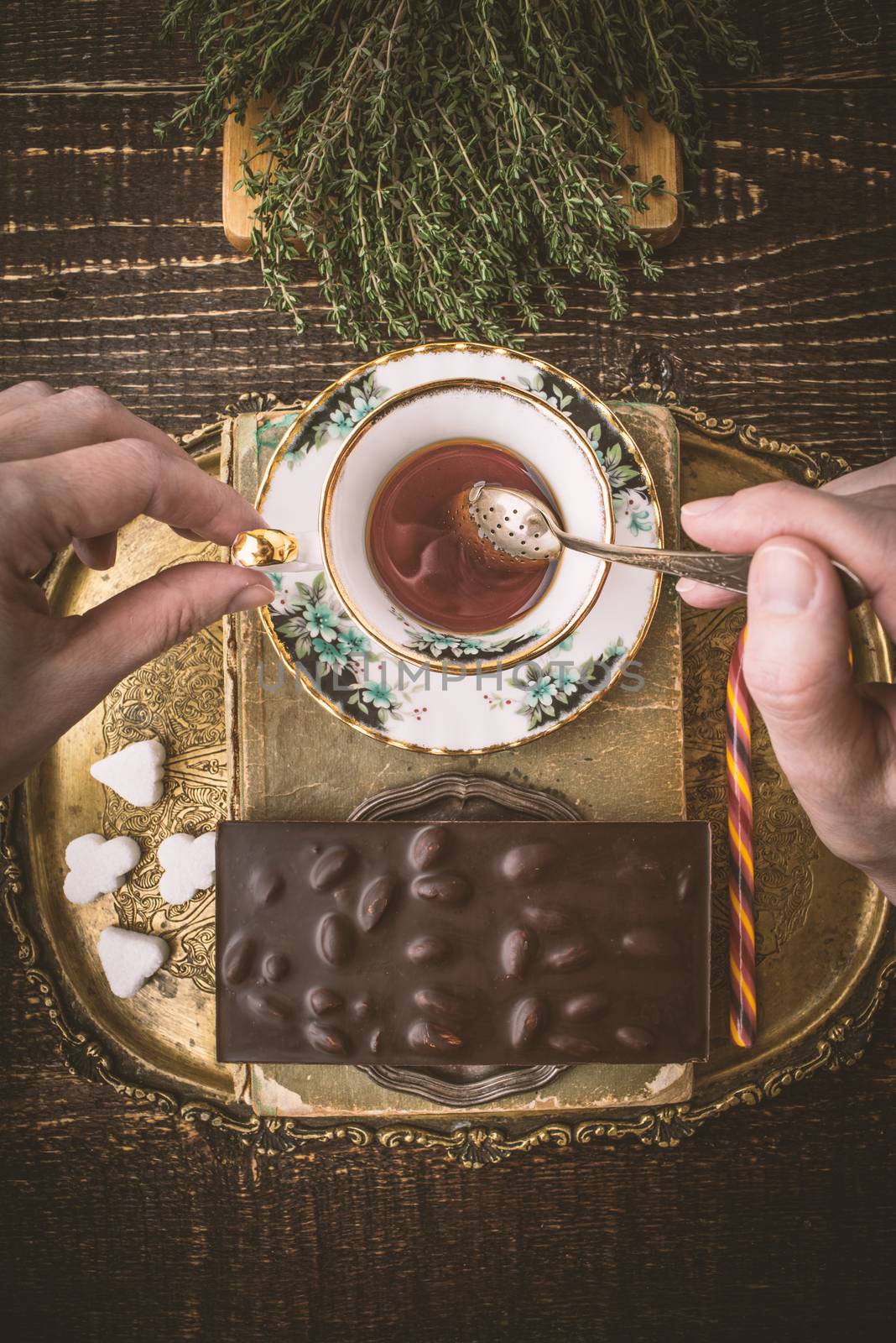 Drinking tea with chocolate vertical by Deniskarpenkov
