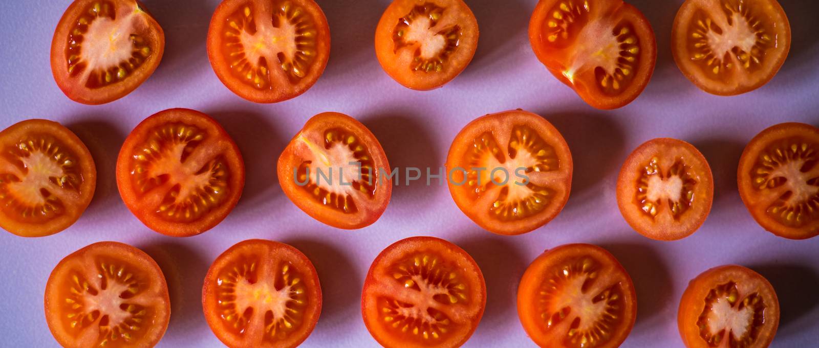 Tomato halves on the white background wide screen by Deniskarpenkov