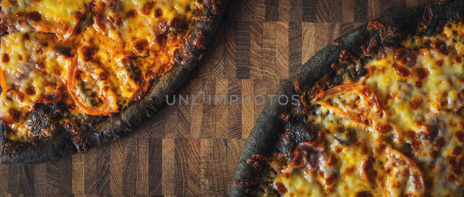 Dough black pizza on the wooden table wide screen by Deniskarpenkov