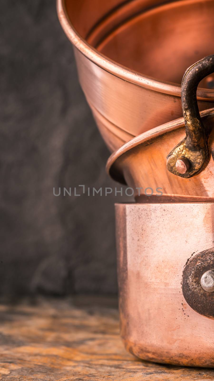 Copper pots and pans on the stone table