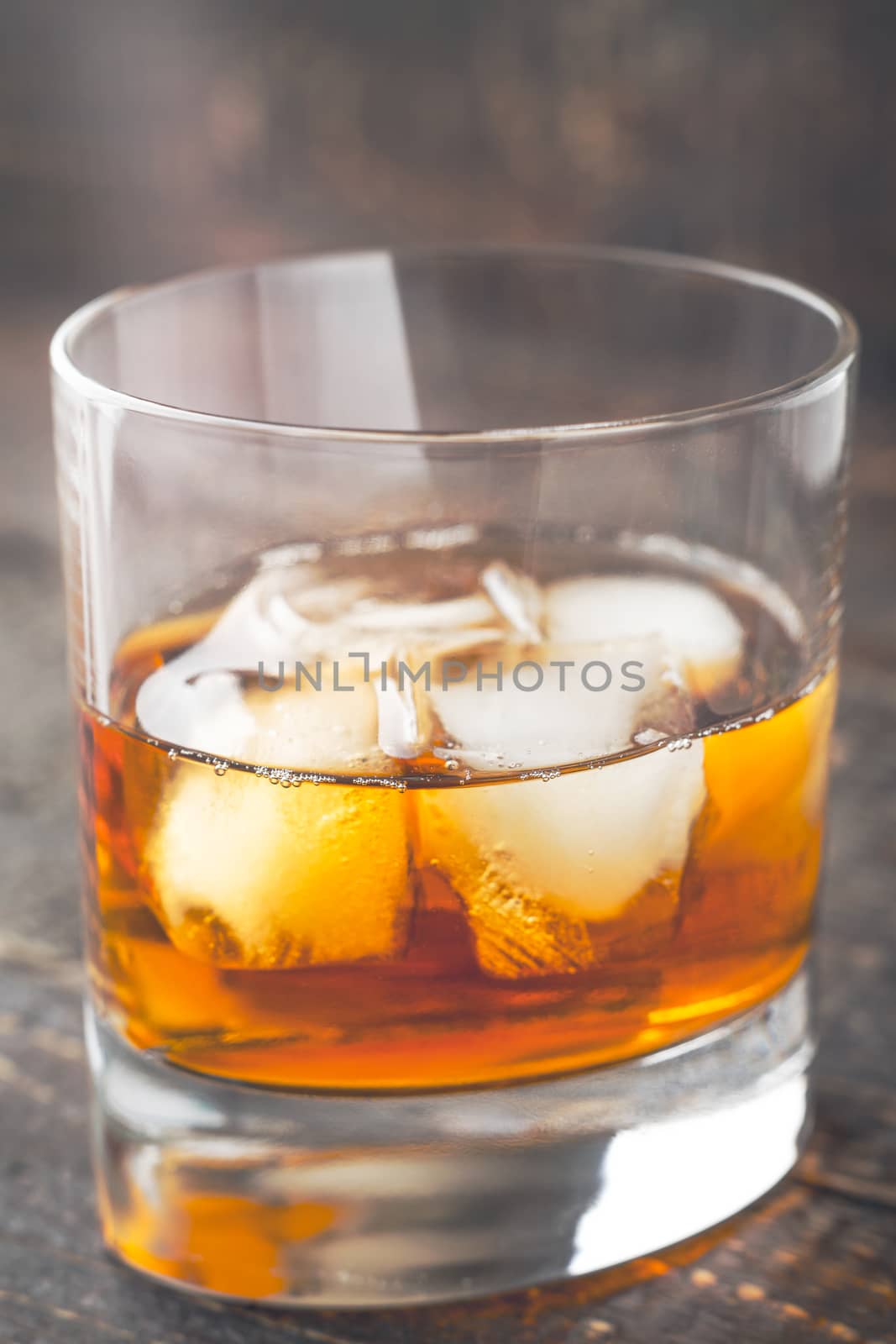 Whiskey with ice  on the wooden table