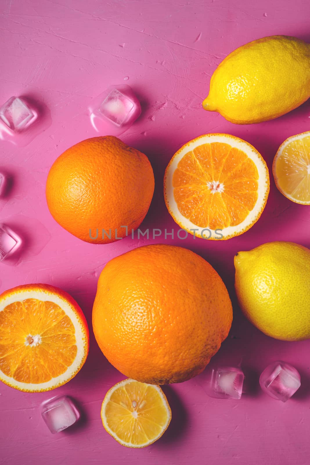 Citrus mix on the bright pink background top view by Deniskarpenkov