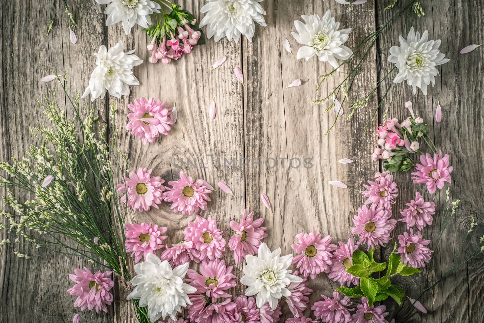 Composition of different  flowers on the wooden background top view