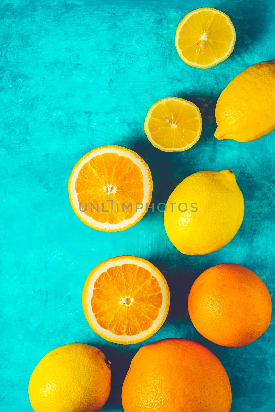 Lemons and oranges on the cyan background vertical by Deniskarpenkov