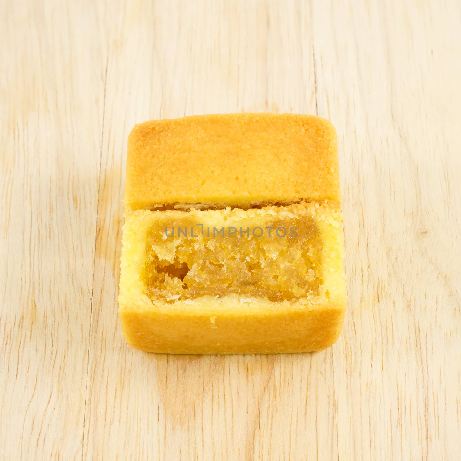 The tasty Taiwanese pineapple pastry cake with egg yolk on the wooden plank.